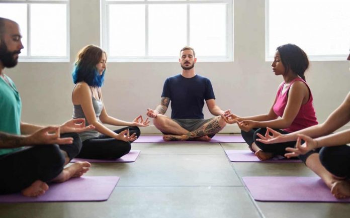 Practicing group yoga is good for body and soul